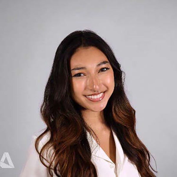 A person with long hair smiling