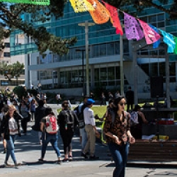 Students walking in Malcolm X Plaza on a sunny day